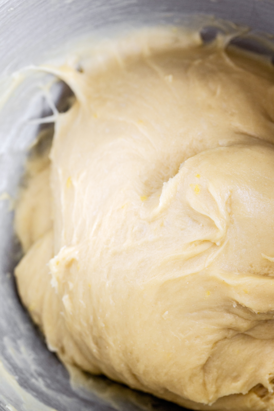 Donut dough in a bowl, ready for its first rise, perfect for baking and dough preparation photography.